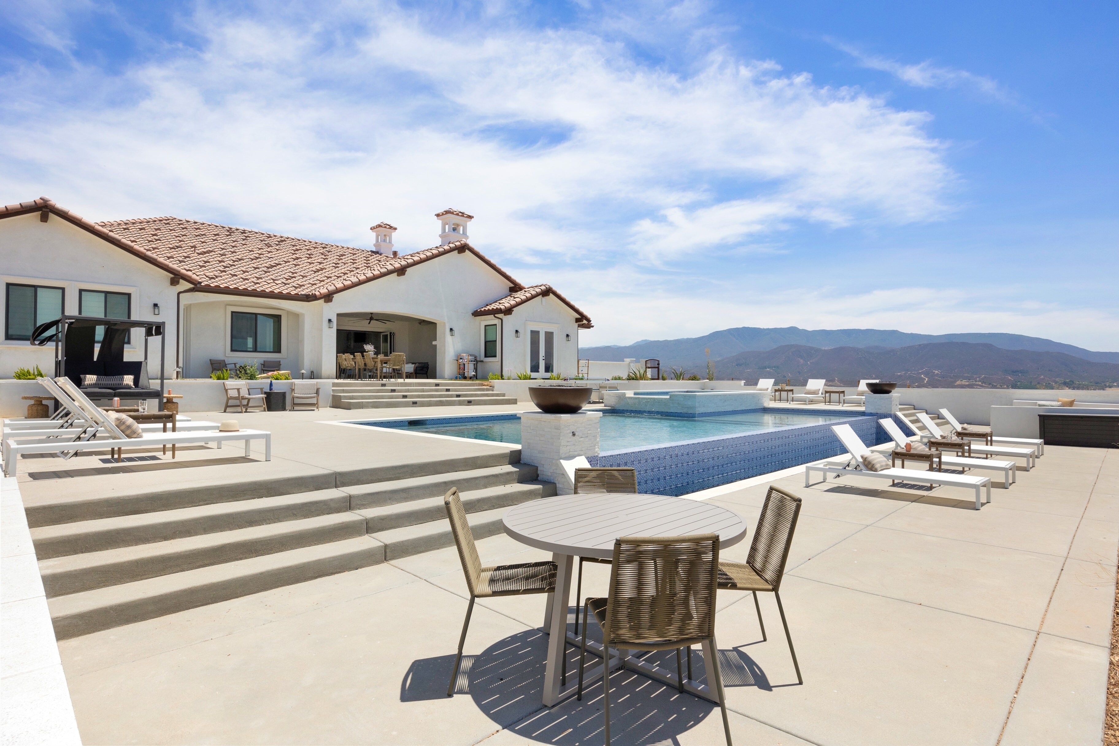 Stunning pool surrounded by open space and views.