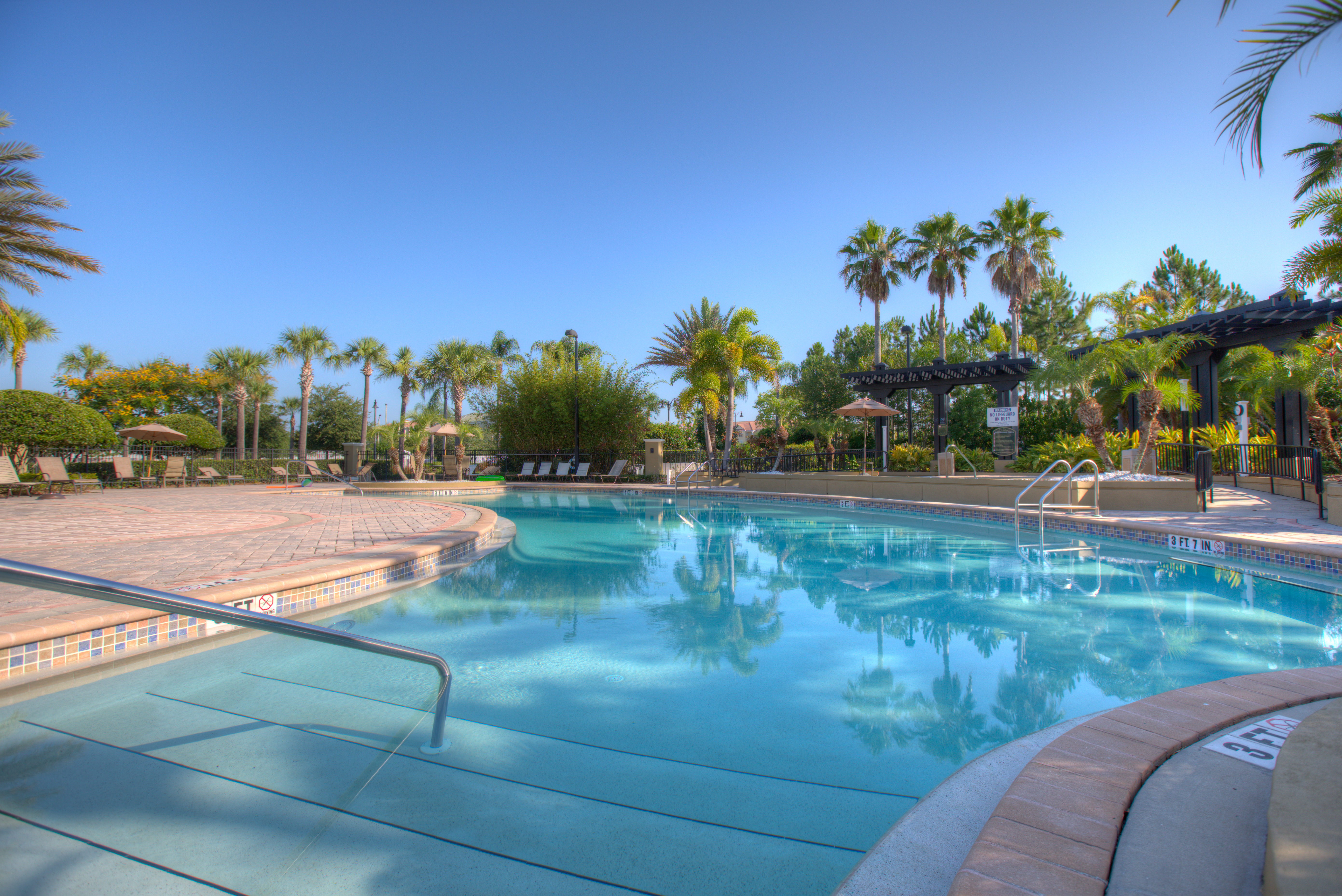Discover serenity at the Vista Cay Resort Isles Pool: A tranquil oasis nestled amidst picturesque landscapes, inviting guests to unwind and soak up the Florida sun in peaceful seclusion.