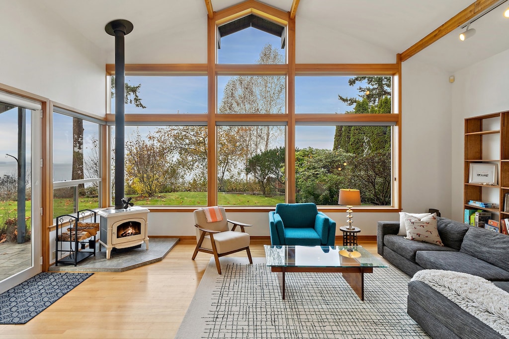 Cozy up by the wood-burning fireplace and soak in stunning lake views through soaring picture windows.