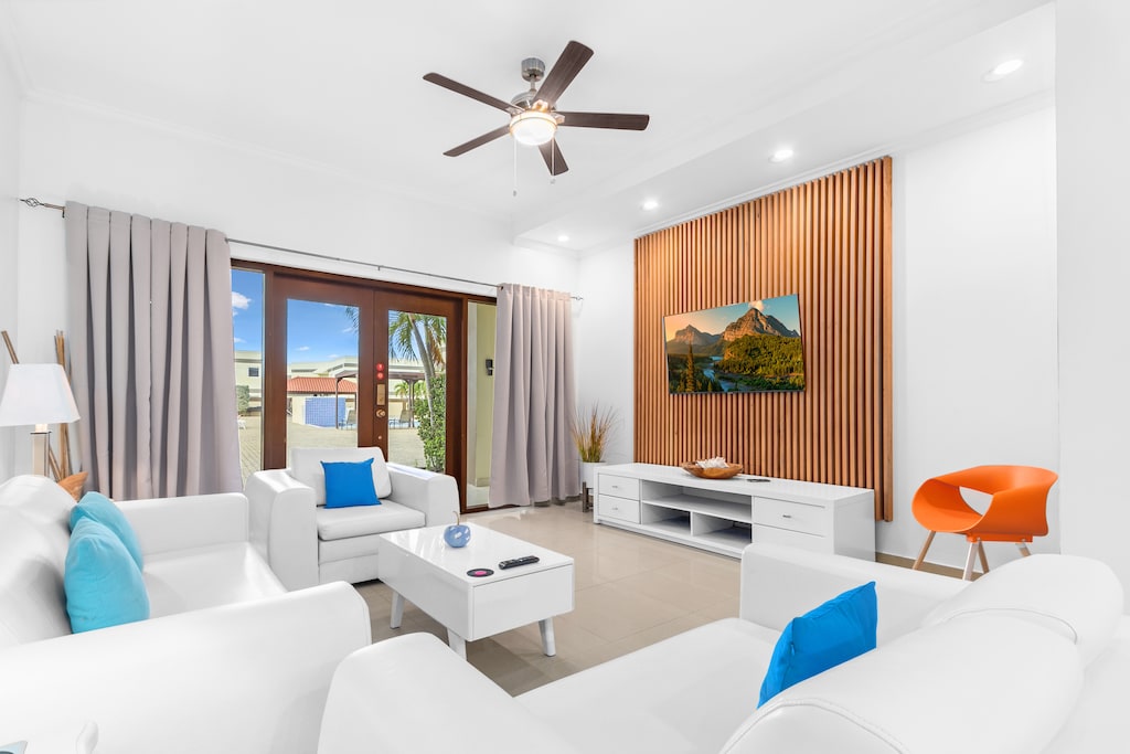 Magnificent Living Area of the 2BR Condo in Noord Aruba - Living room area with sliding door for easy access to pool - Smart TV and Netflix - Comfy Seating Arrangements