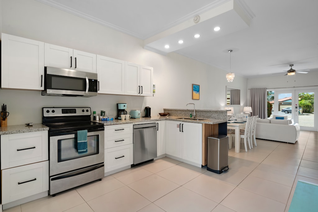 Enchanting Kitchen of the 2BR Condo in Noord Aruba - Fully equipped kitchen with stainless steel appliances - Integrated appliances for a seamless and stylish appearance
