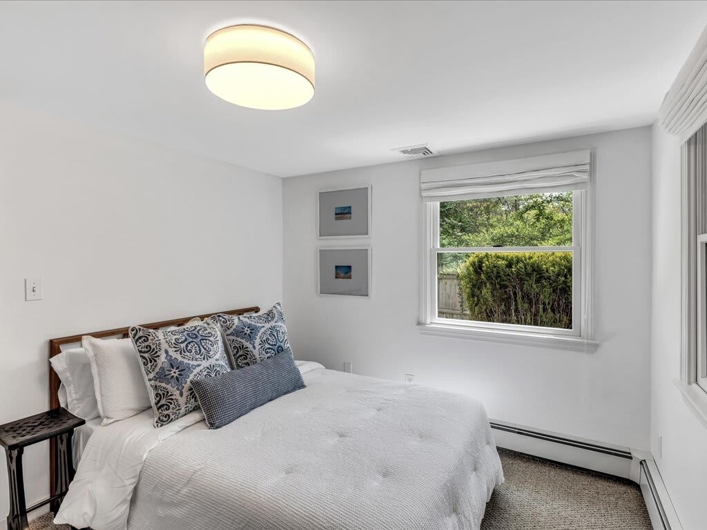 Chic and tranquil, this first-floor bedroom combines modern touches with plush comfort, designed for those who appreciate style and serenity.