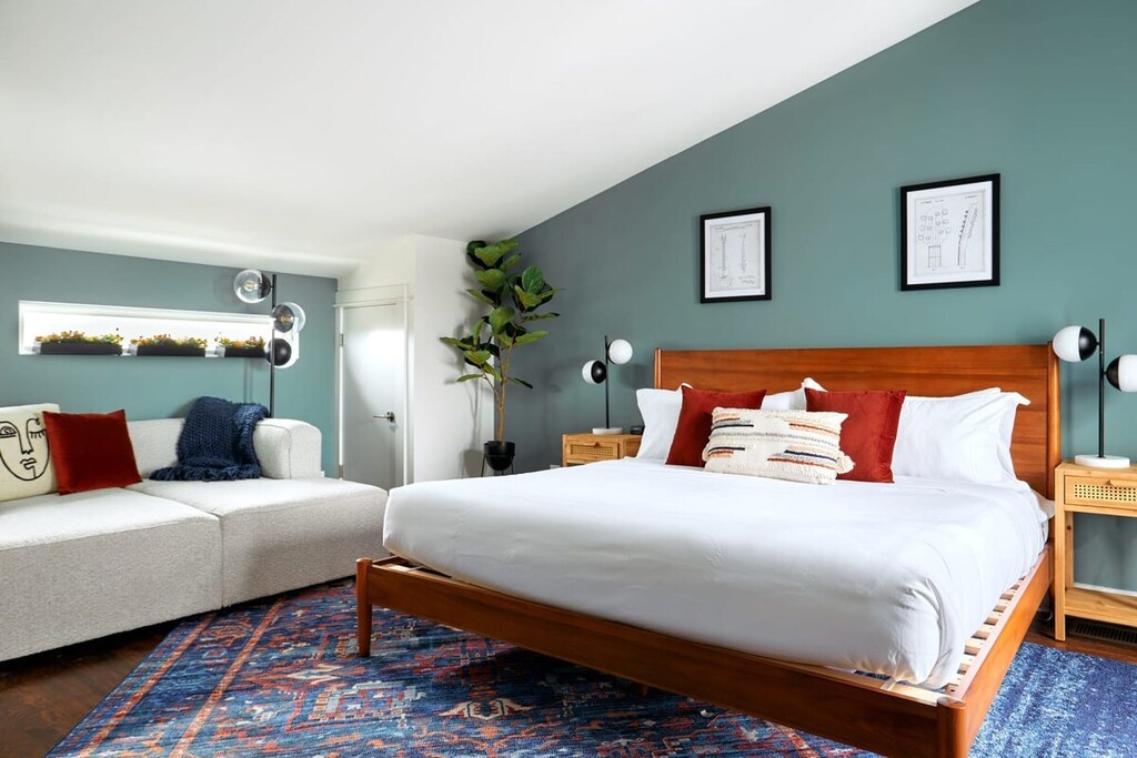 The top-floor king bedroom offers direct access to the rooftop deck for stunning views and private relaxation.