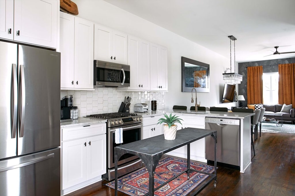 Transition seamlessly from the well-equipped kitchen to the stylish living area or onto the first of our two inviting decks.