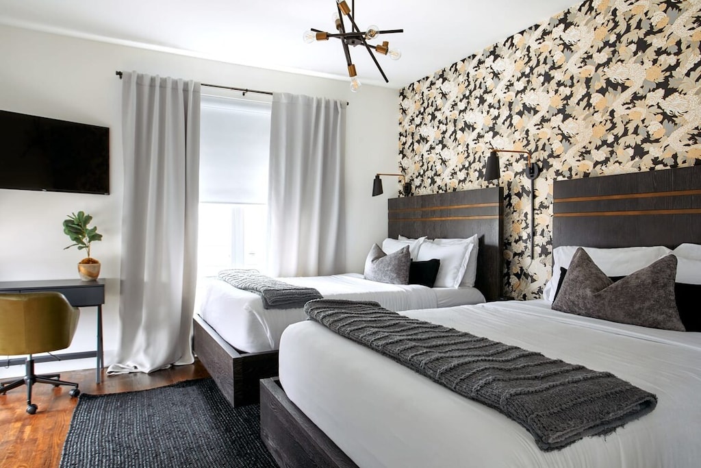 Work and relax in comfort with two queen beds and a dedicated workspace in this spacious room.