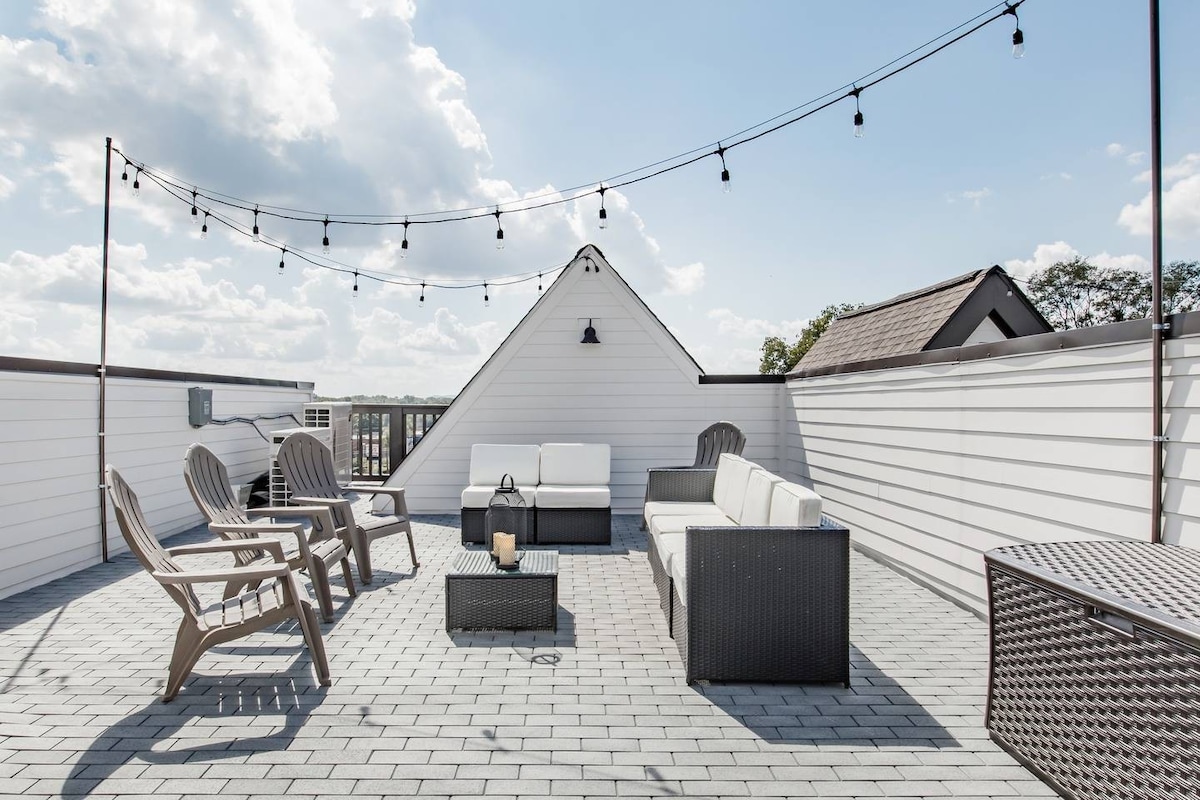 Gather on the rooftop deck illuminated by charming string lights.