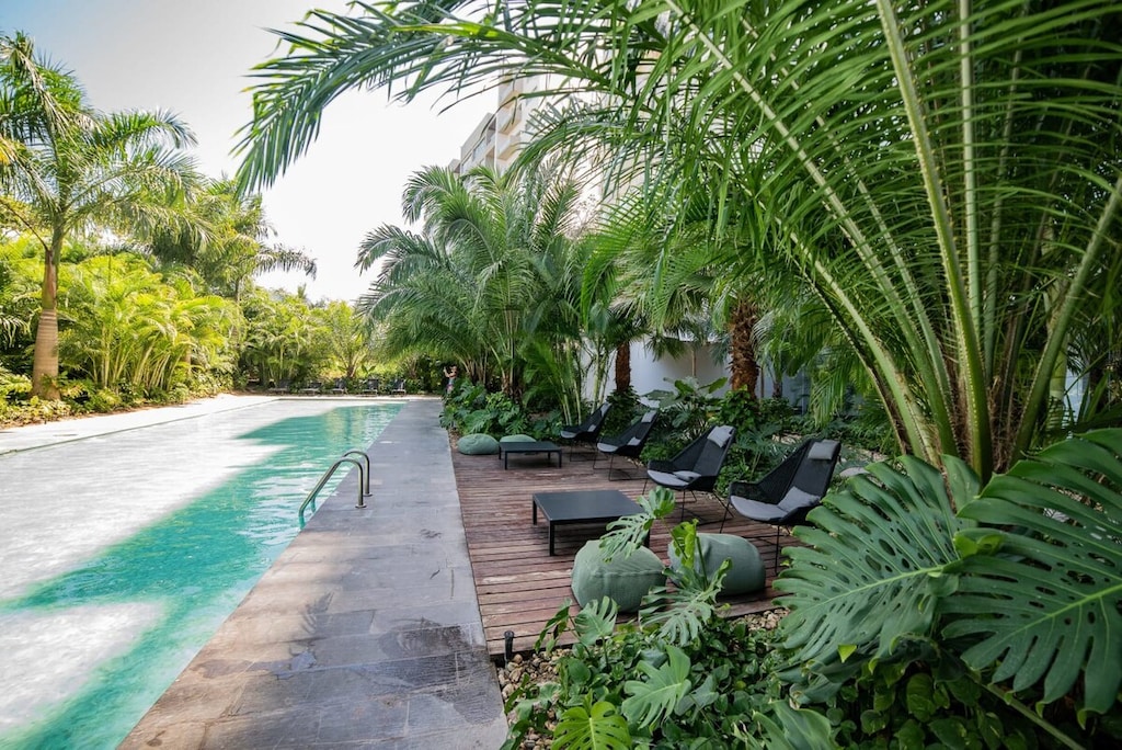 A semi-olympic swimming-pool surrounded by lush, Tropical vegetation, where you will relax after a shopping day.