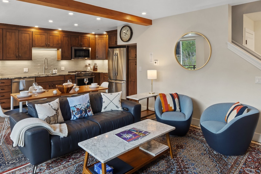 The first level opens up to a large living room, kitchen and spacious deck with plenty of natural light and a gas fireplace.