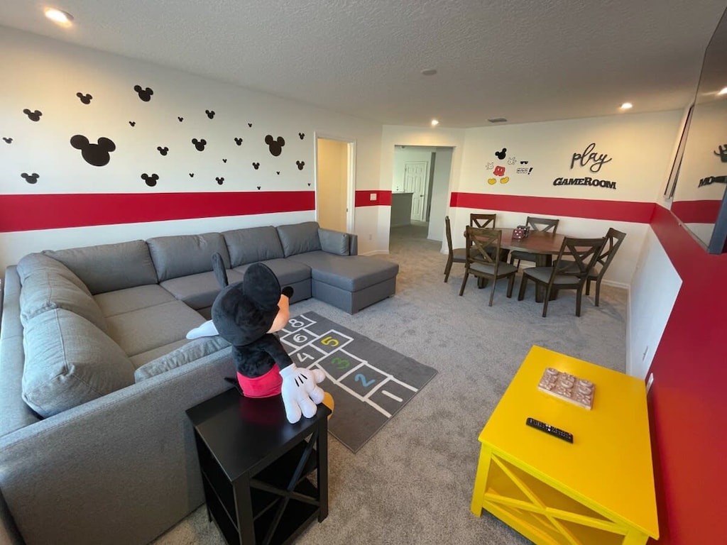 Dive into fun in this Mickey Mouse-themed game room, featuring cozy seating and playful decor for memorable family gatherings.
