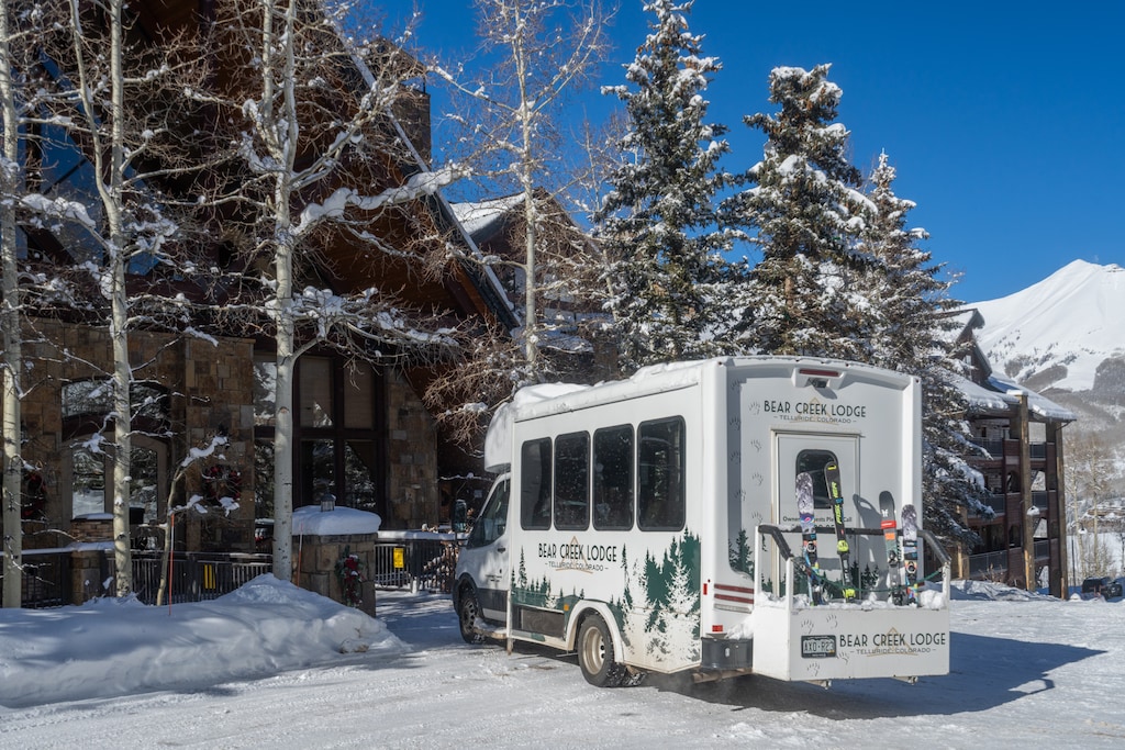 Snow-covered mountain retreat with convenient shuttle service to nearby ski slopes and winter activities.