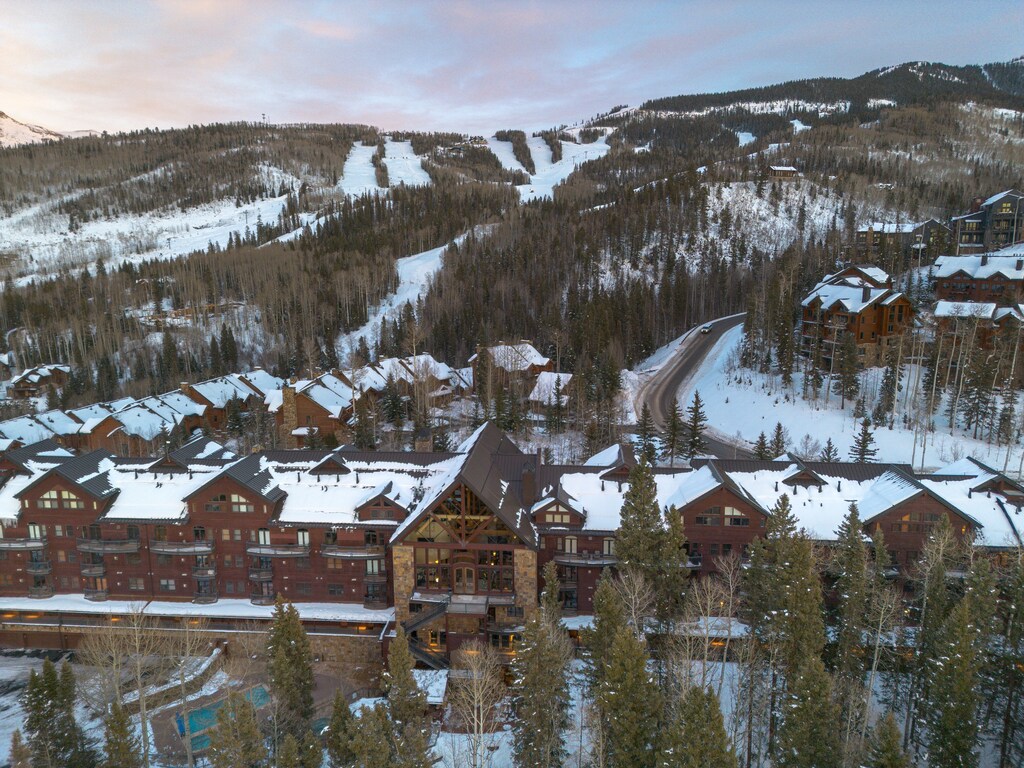 Alpine ski resort village nestled beneath pristine powder slopes, offering winter mountain adventure and cozy accommodations.