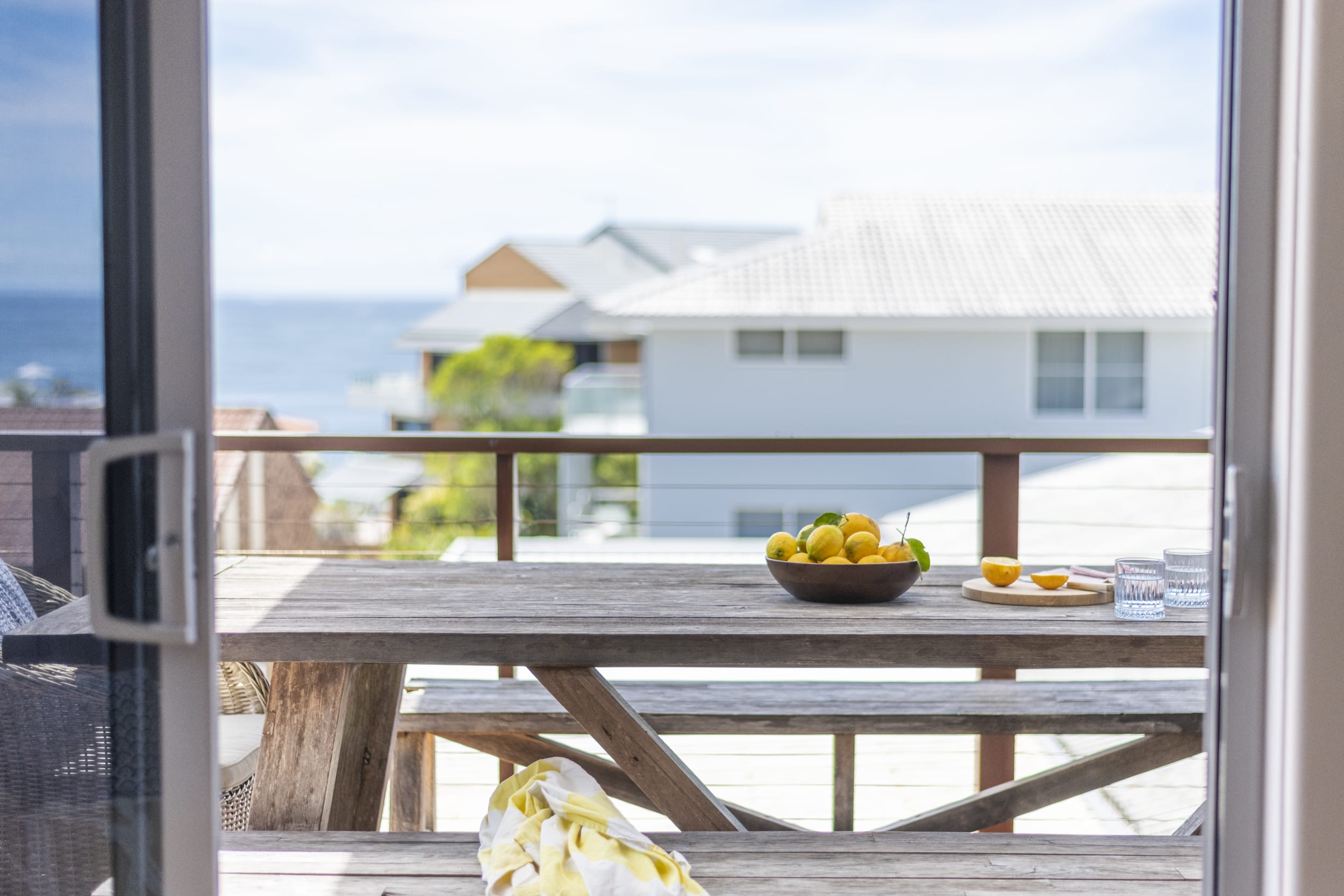 Bimbajong Main Beach - Coast accommodation in Yamba town with Ocean views - Upstairs rear balcony with outdoor dining setting and ocean views
