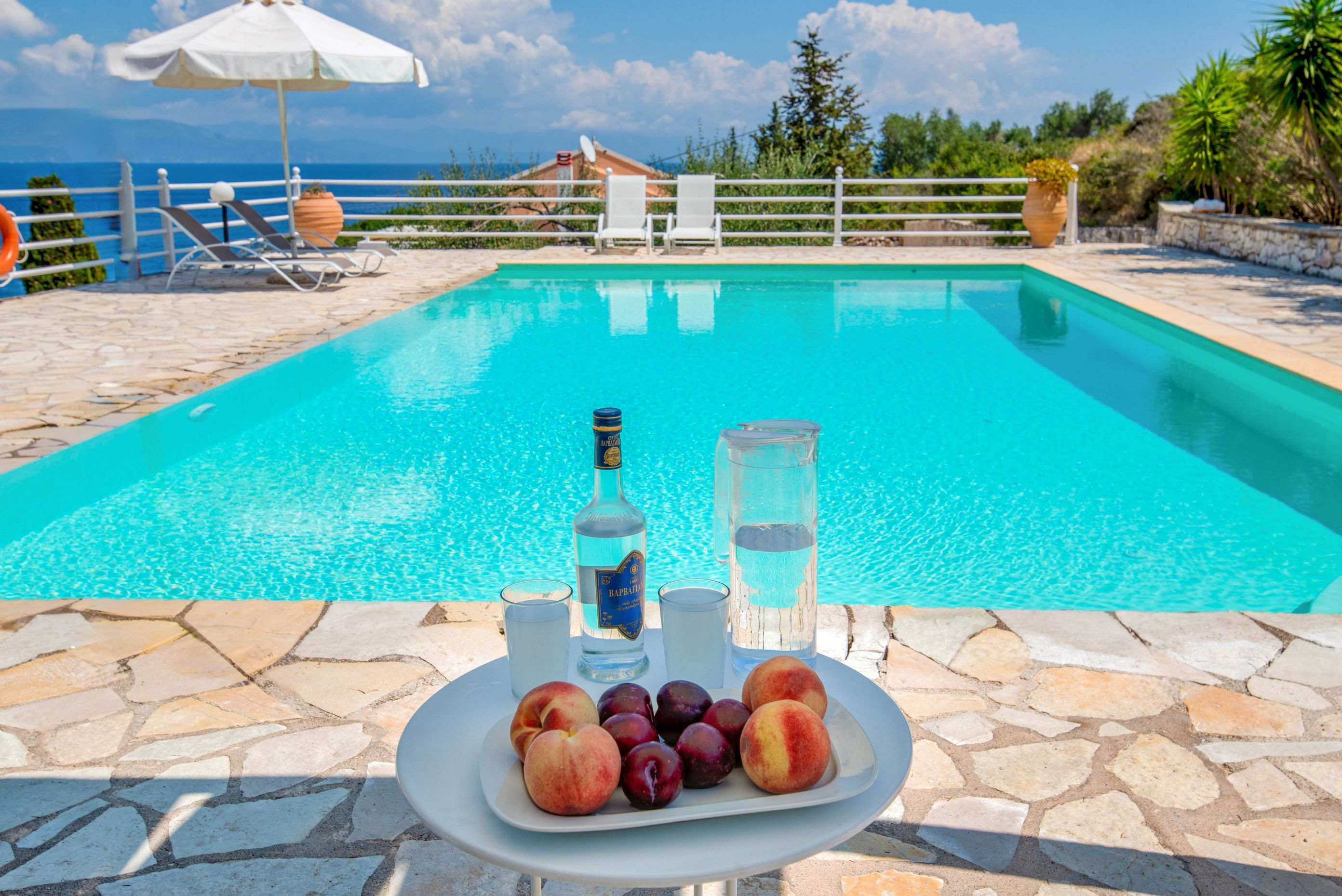 Relax by the outdoor pool at Petros