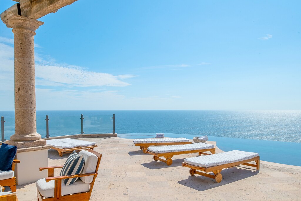 Sunny patio with lounge chairs and outdoor seating