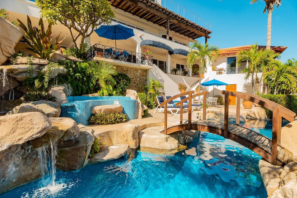 Patio with infinity pool and walkway bridge