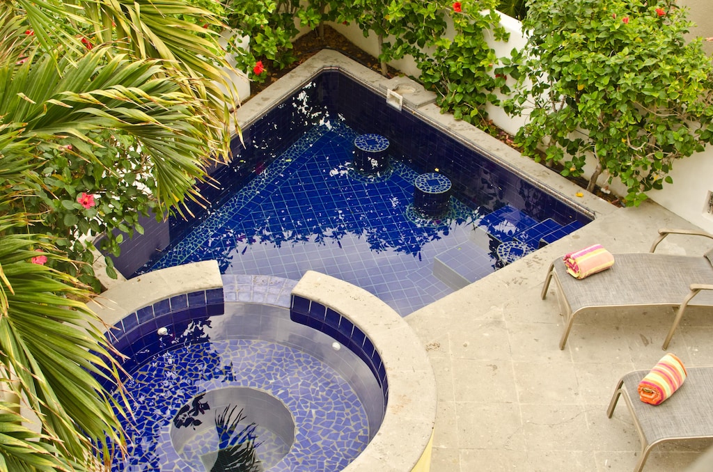 Patio with lounge chairs, pool and jacuzzi