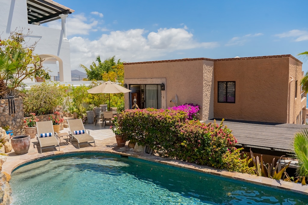 Stone patio with sun deck and pool