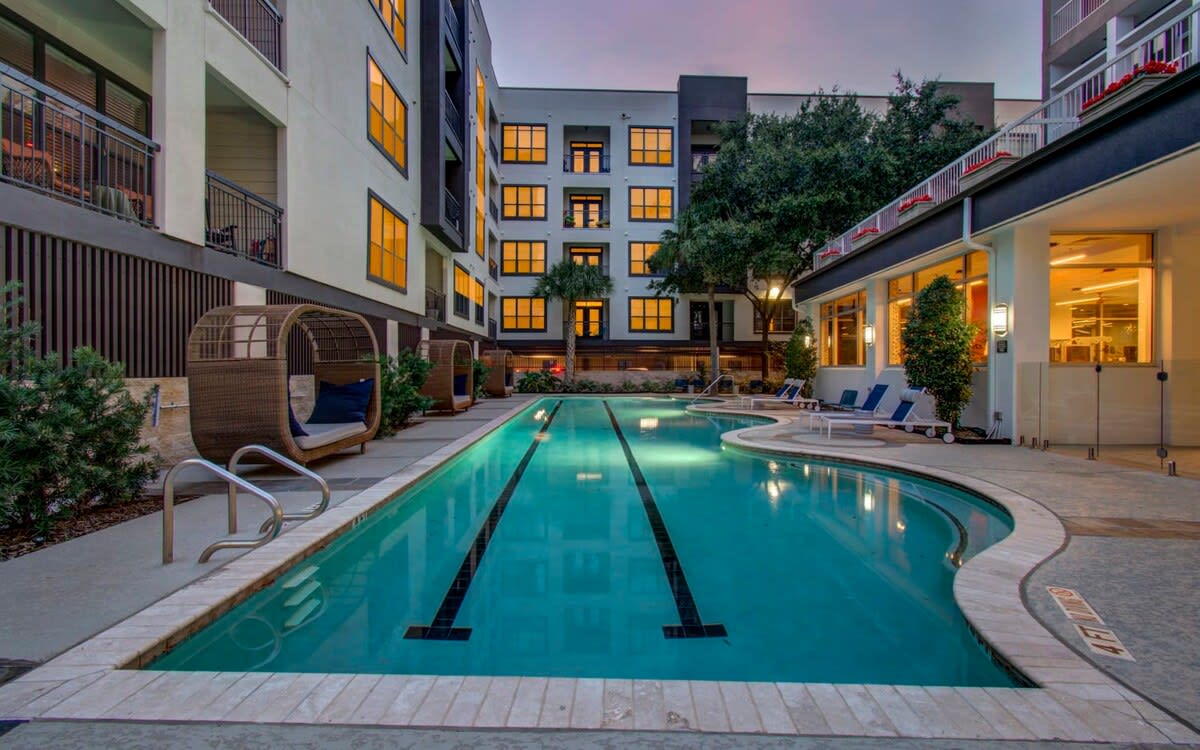 This resort-style pool offers you a tropical oasis to call your own, including poolside loungers and palm trees!