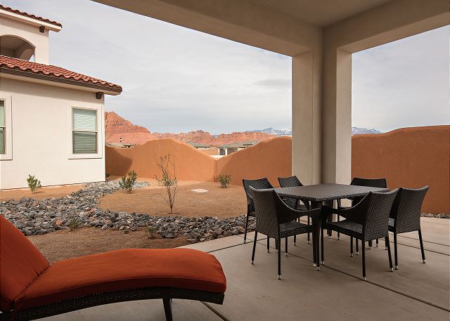 Covered patio off dining area with additional seating and views of surrounding red rocks