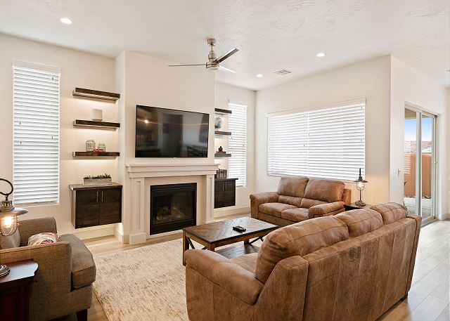 Comfortable main floor family room with a 65in TV, fireplace, and plenty of seating