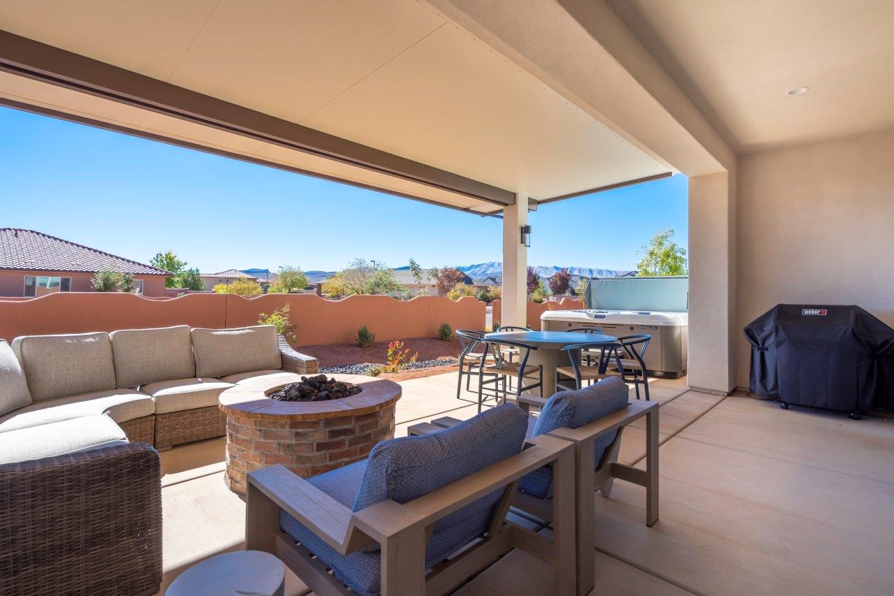 Epic back patio with a private hot tub, fire pit, and lounge seating