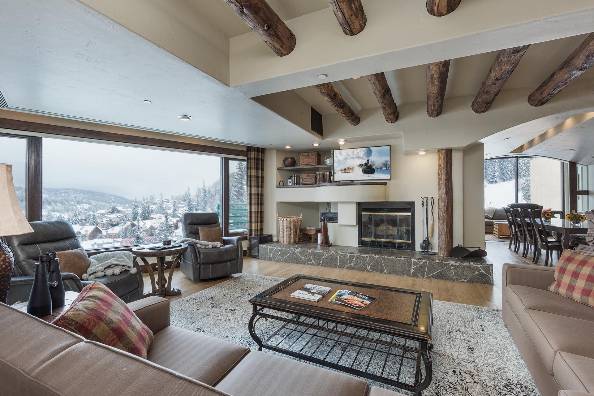 Main Living Space - TV, Wood burning fireplace and awesome picture window of the slopes