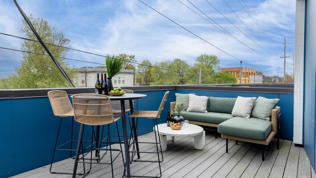 Private balcony with an al fresco dining area and comfortable lounge seating.