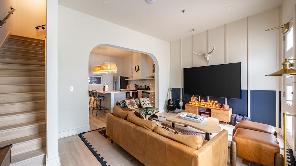 Living room features seating and a TV.