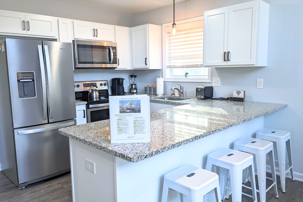 A modern kitchen with sleek countertops and stainless steel appliances.