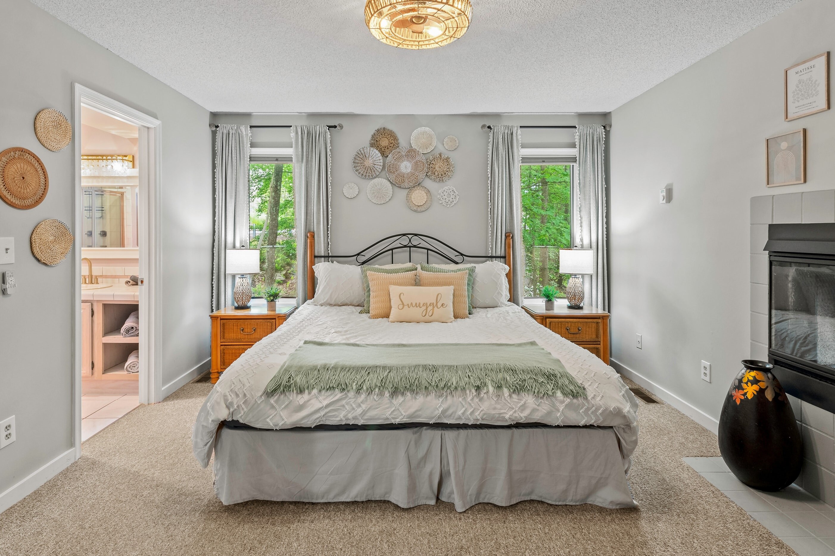 The primary bedroom features a king-sized bed, TV, fireplace, and ensuite bathroom.