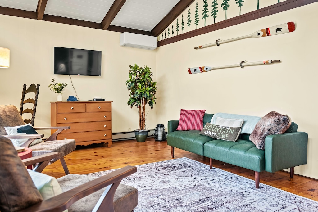 The primary bedroom features a living space with a flat-screen TV.