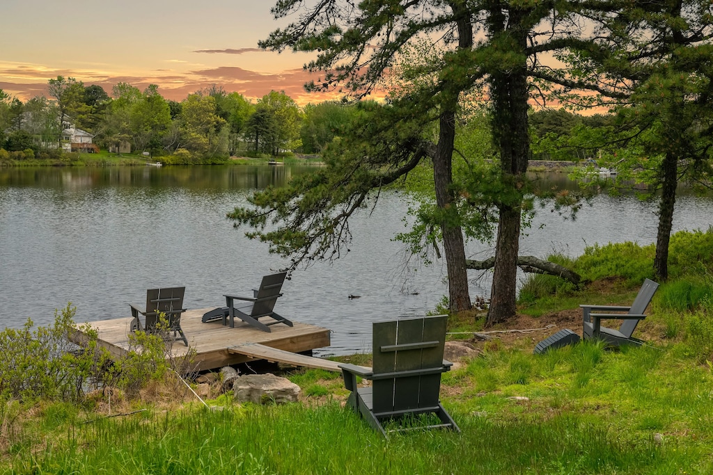 Tranquil dock with seating and breathtaking sunset and water views — the perfect spot to unwind.