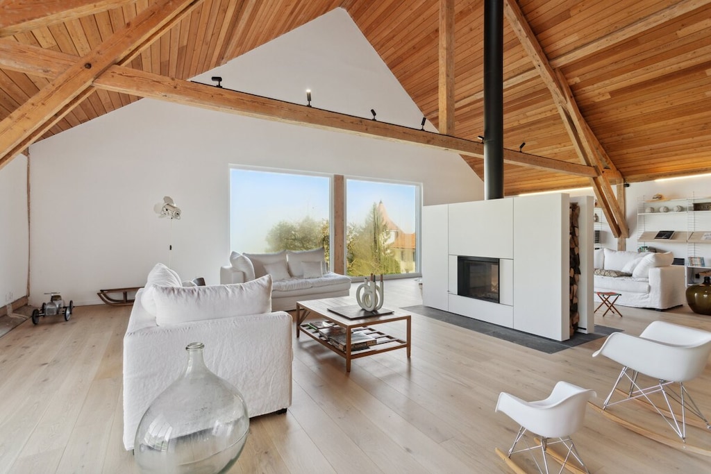 Spacious, modern living room with a high, vaulted ceiling