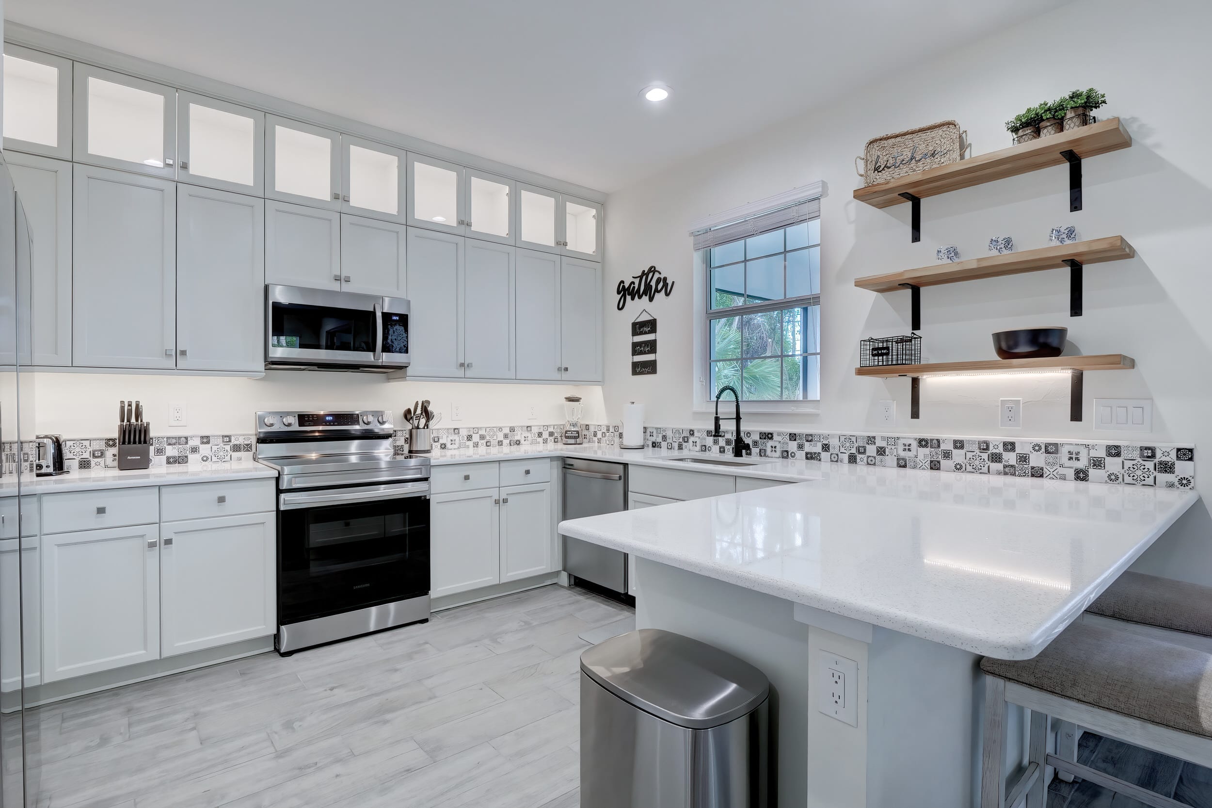 Our Kitchen Features Bright Lighting, Stainless Appliances and a Counter Height Barstools to have an Informal Meal