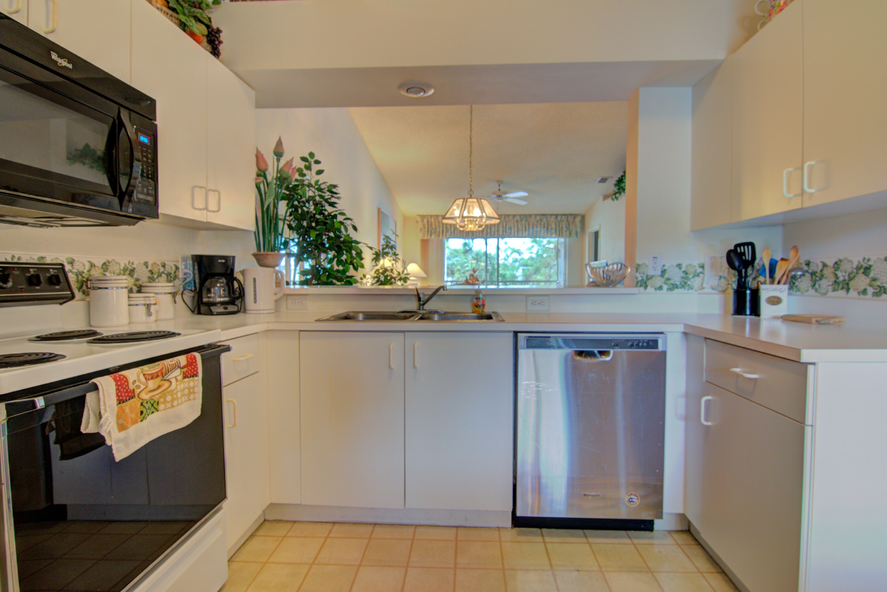 The Kitchen Has An Electric Stove and Plenty of Cabinets