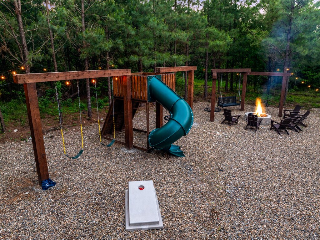 Corn hole boards across from swing set