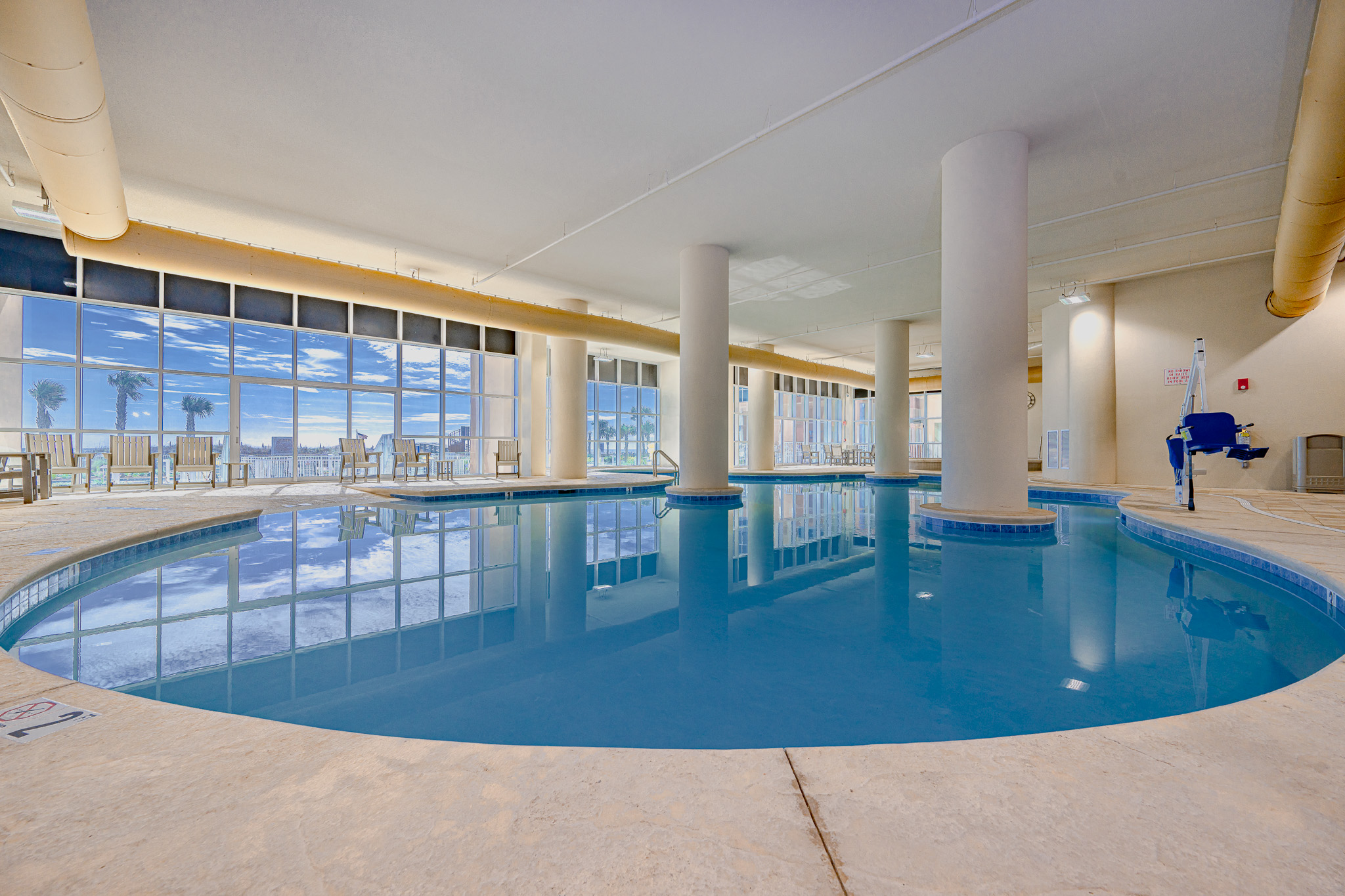Relax by the indoor pools with stunning views of the beach and comfortable seating for a perfect getaway experience