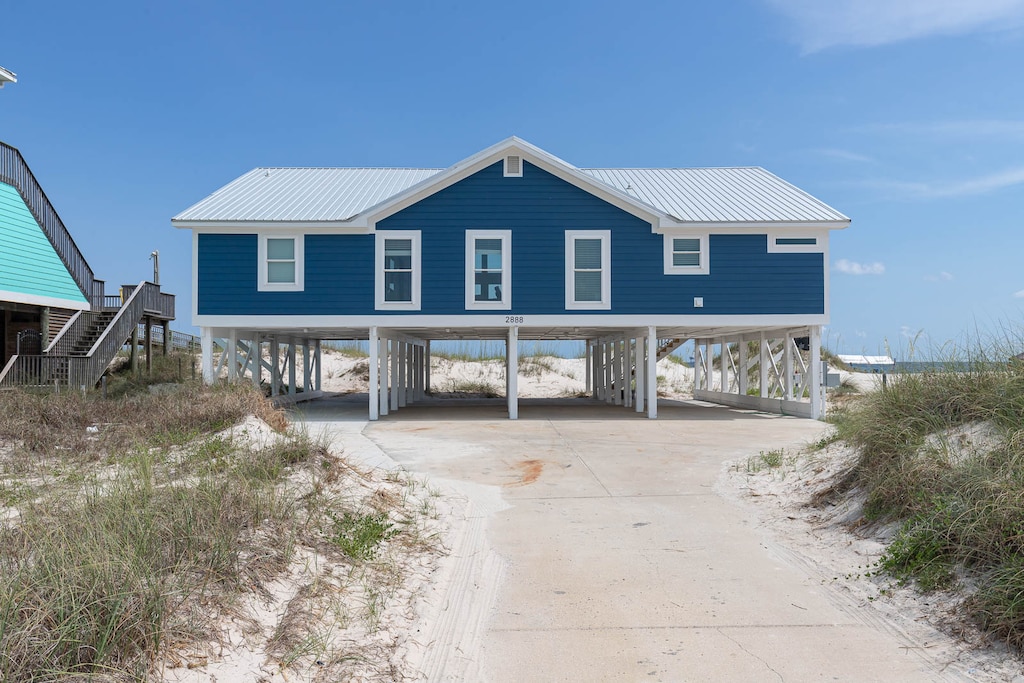 Enjoy a charming beachfront retreat with a vibrant blue exterior, perfect for relaxing and soaking in the coastal vibes