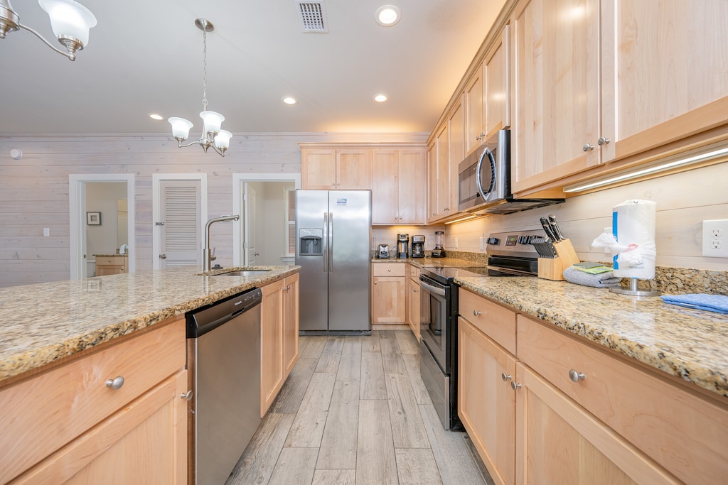 Roomy kitchen with spacious granite countertops, stainless appliances, and coffee station for a delightful cooking experience