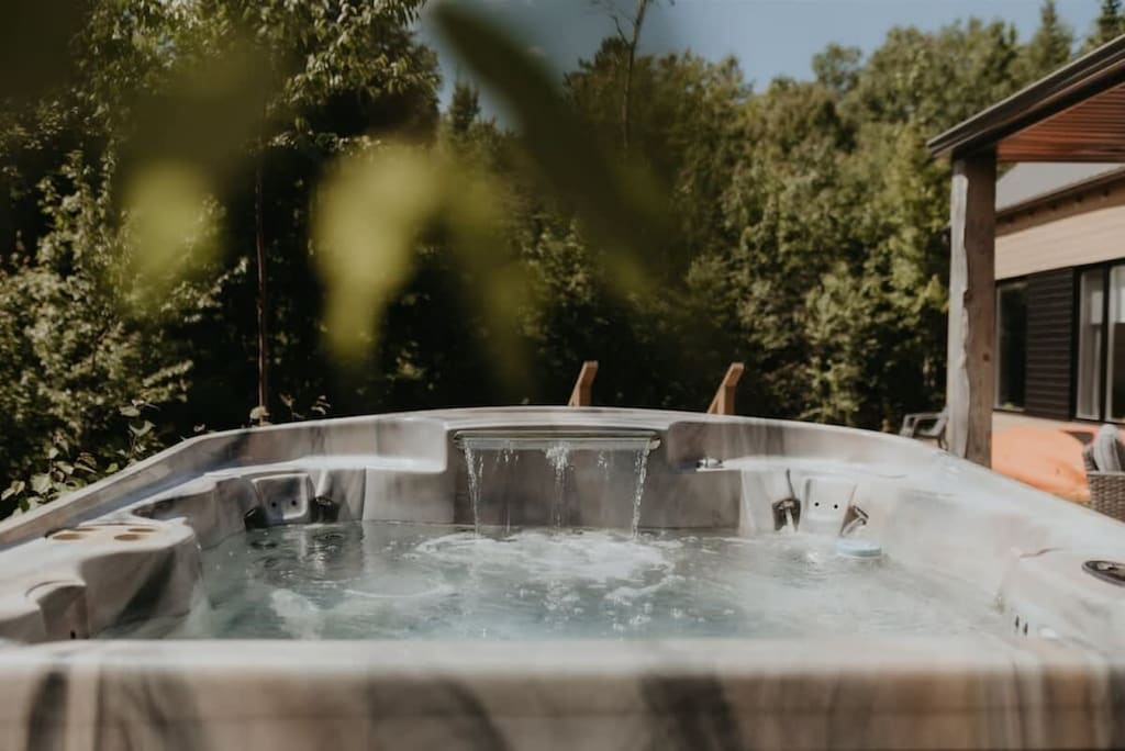 Ease into bubbling warmth, embraced by tranquil forest.