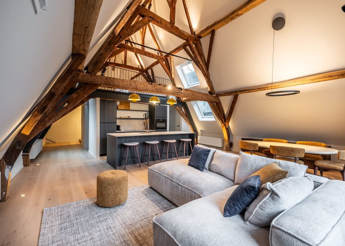 Elegant living space with exposed wooden beams and high ceilings