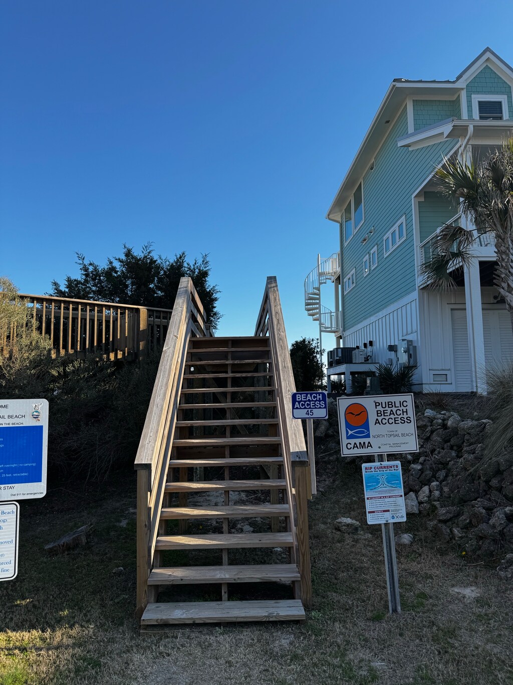 Public beach access directly to the left of the property. The home is in this photo.