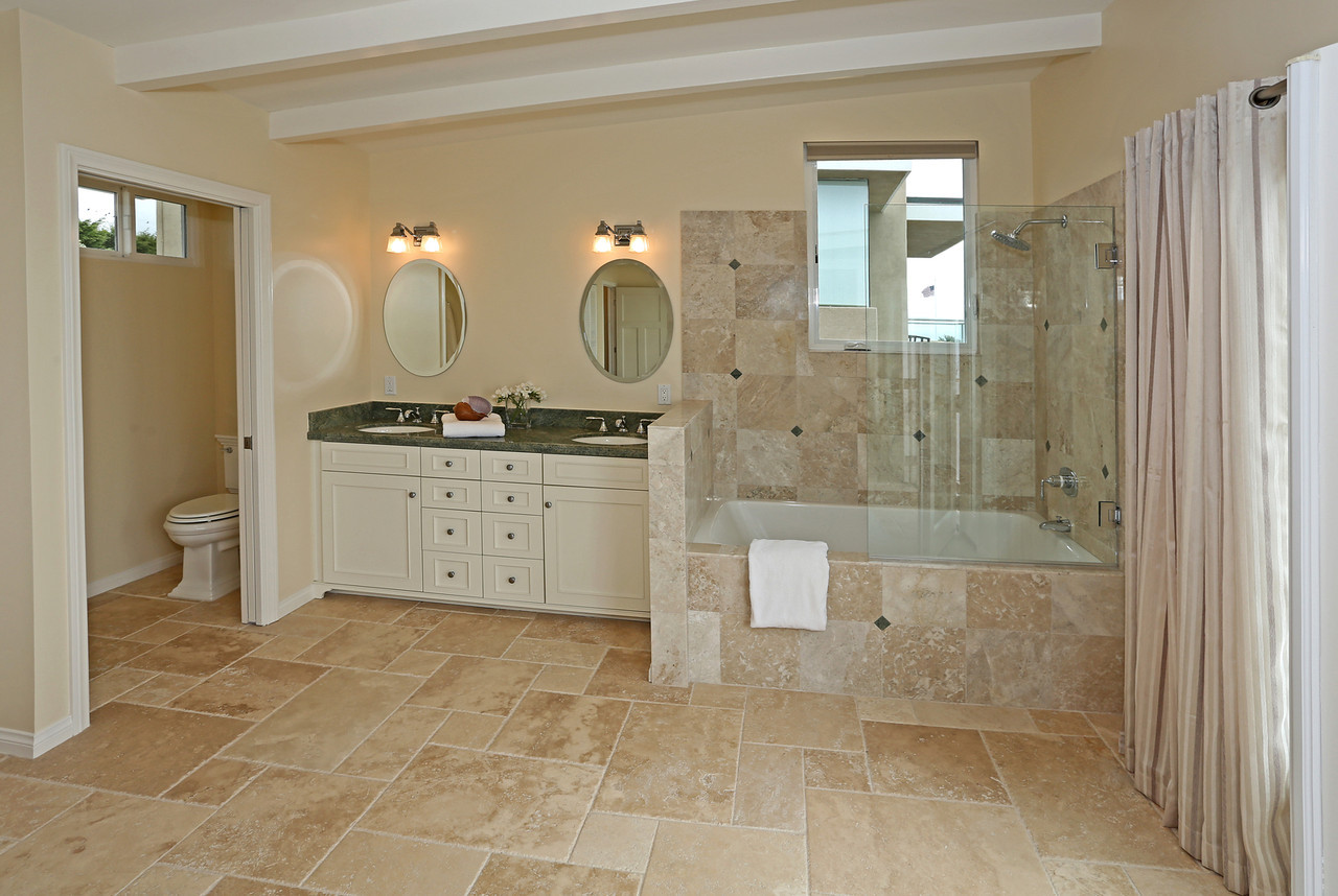 Primary Bathroom with tub/shower combo~ and dual sinks. (studio style)