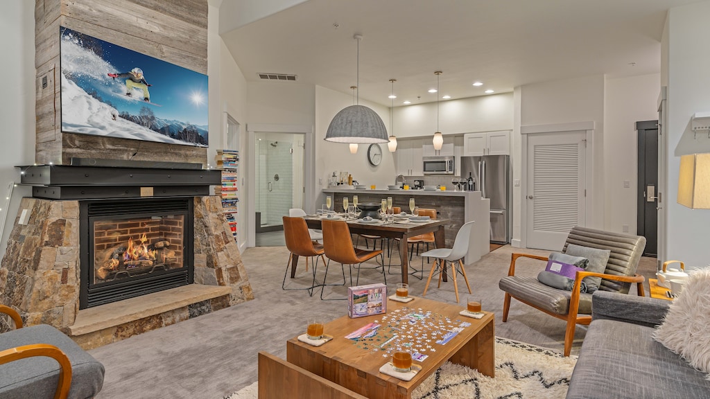 Living room with open floor plan, TV, and gas fireplace