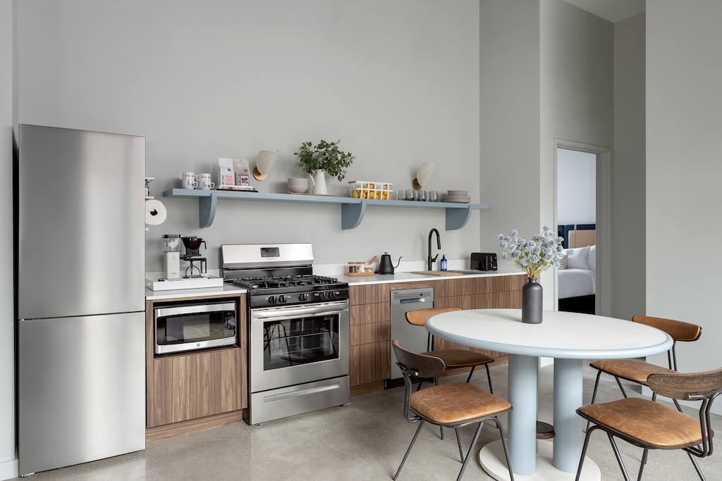 Refrigerator, microwave, oven, stove, kitchen utensils, cookware, dishwasher. dining table with seating for 4. 