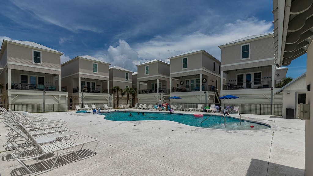 Enjoy a refreshing dip or read a book poolside, perfect for family fun and relaxation in a welcoming atmosphere