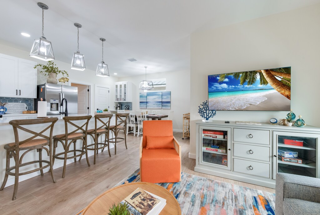 Spacious living, kitchen, dining area with a flat screen smart TV