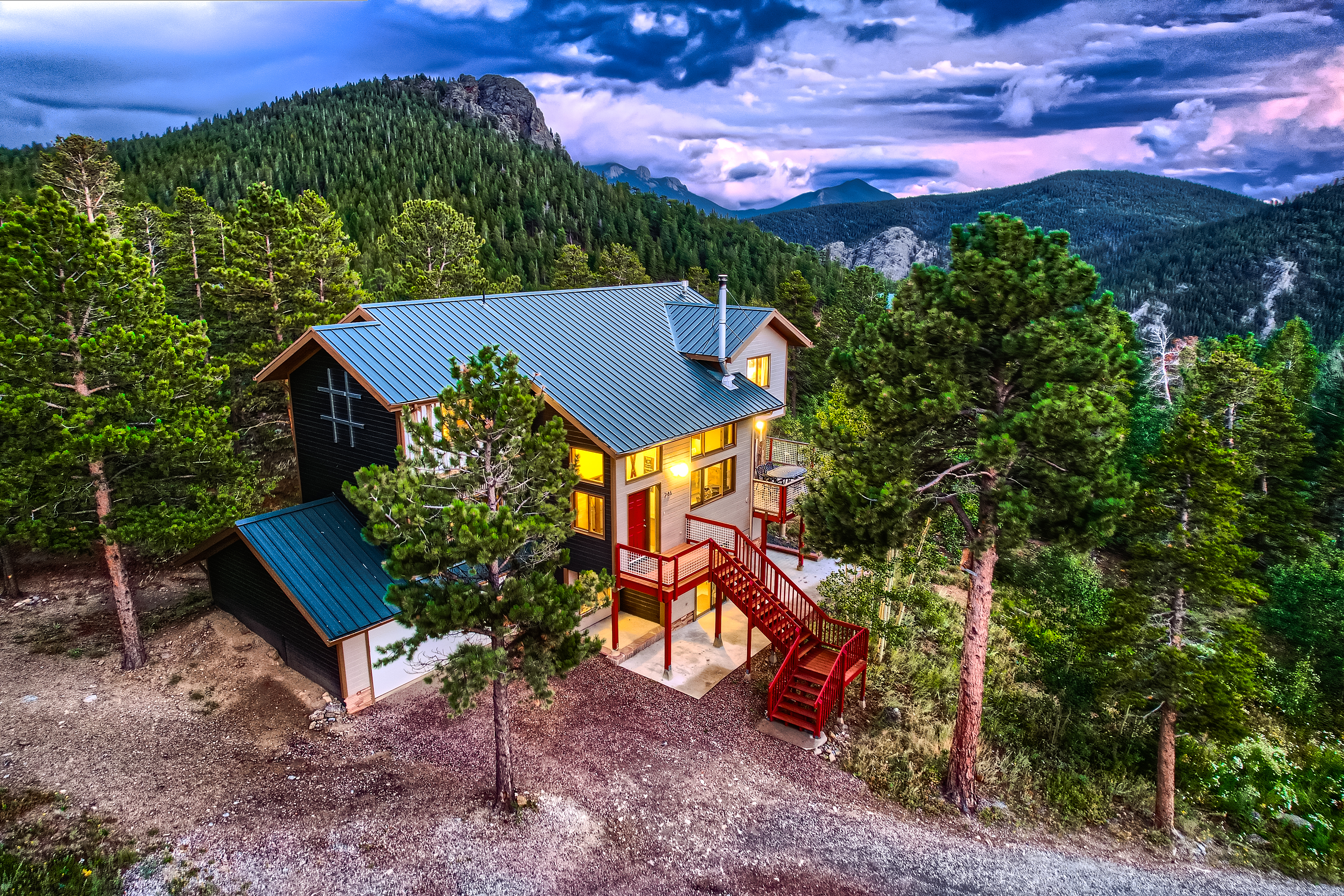 A cabin in the mountains at dusk.