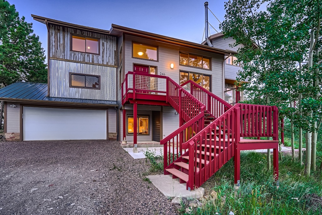 A home with a red staircase in the woods.