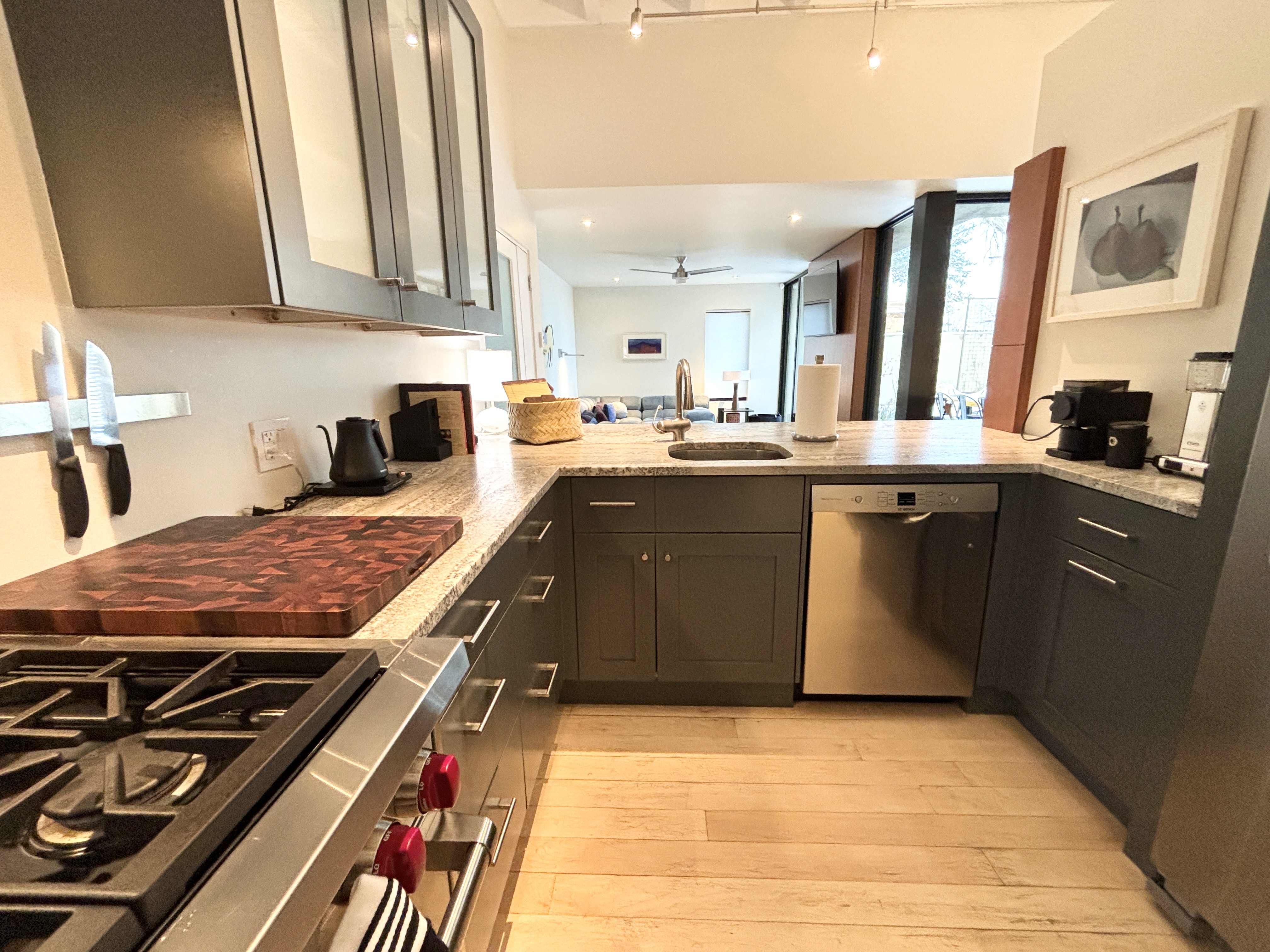A kitchen with grey cabinets and a stove.